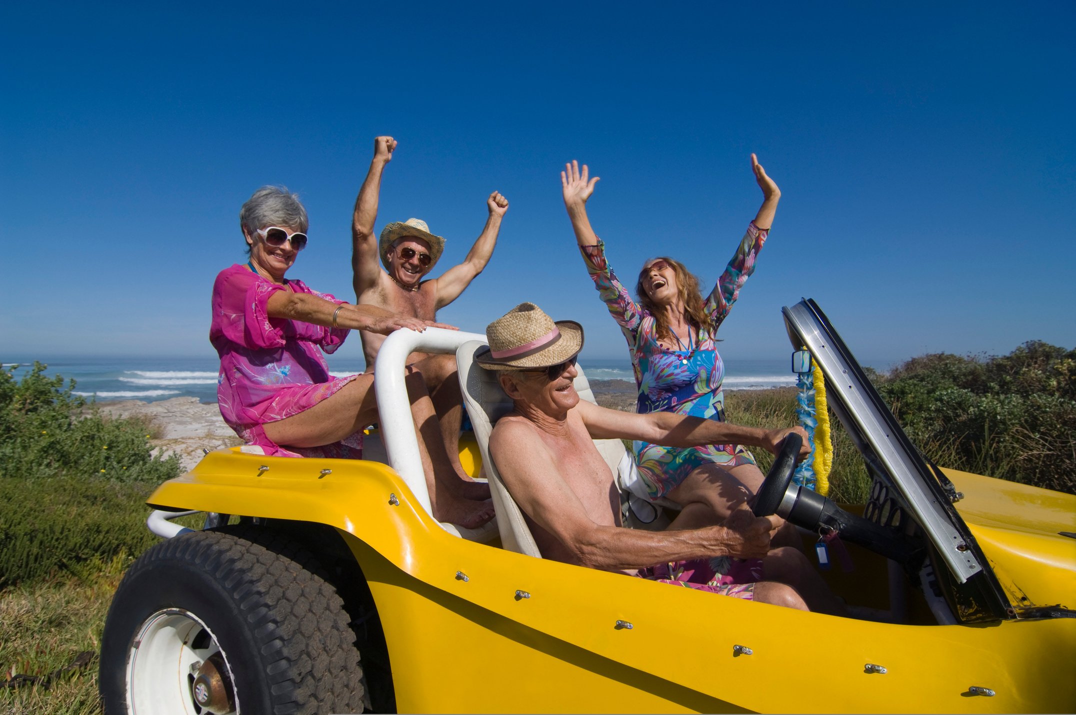 Couples riding in dune buggy