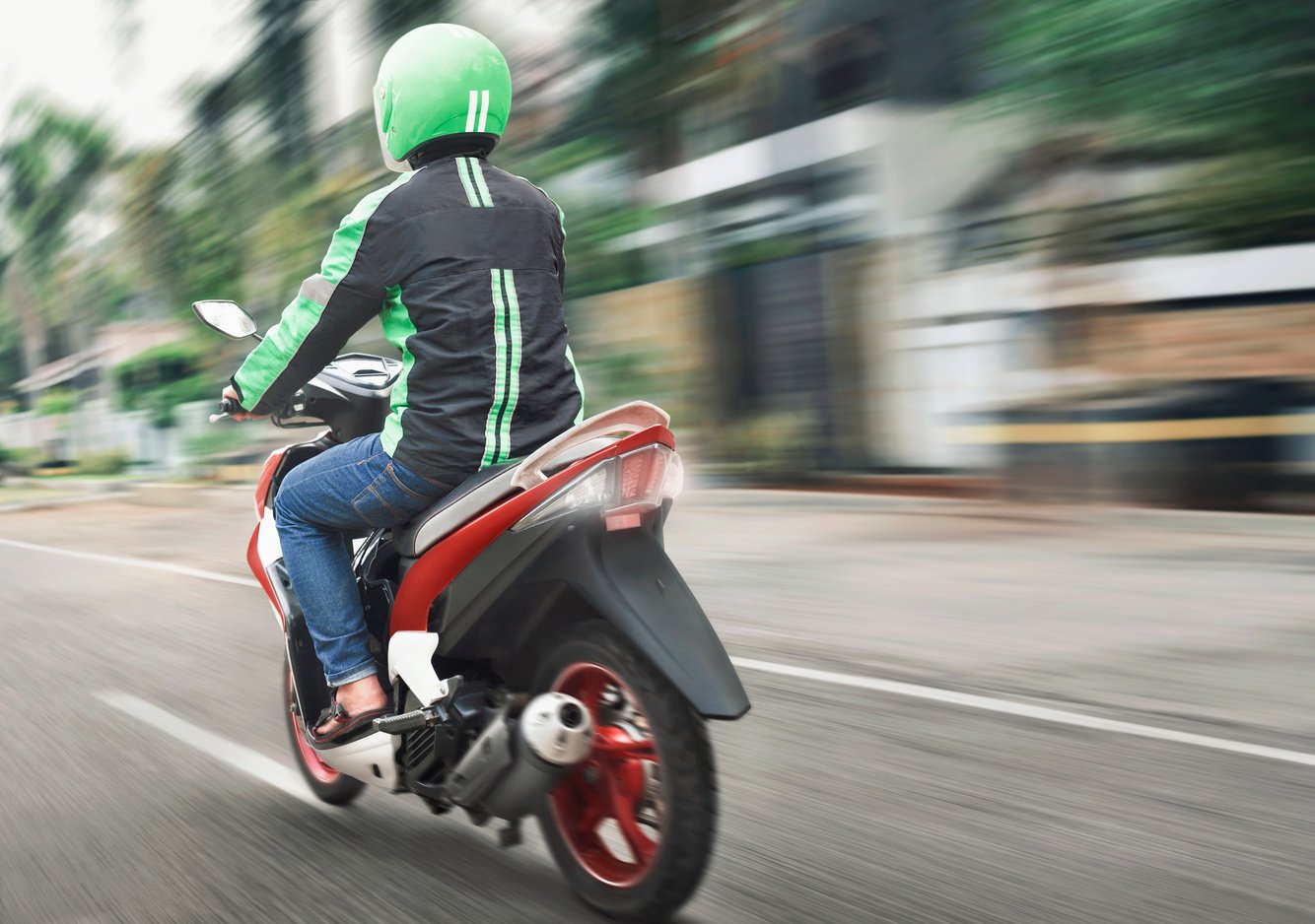 Rear view of motorcycle taxi ride with fast